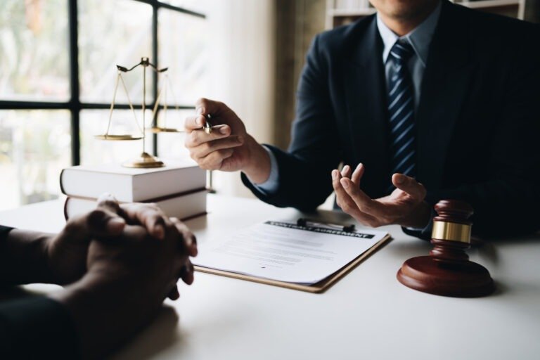 Close up view of professional lawyer explain the details of the contract for his client in office room.