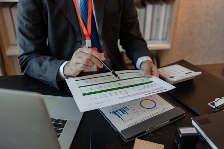 a businessman reviews the company's financial documents in his office, the accountant is rushing to check the figures in the documents before submitting them to the tax office