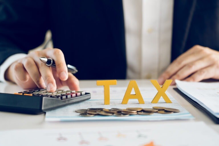 Businessman's hands calculating numbers at a calculator.Tax dedu